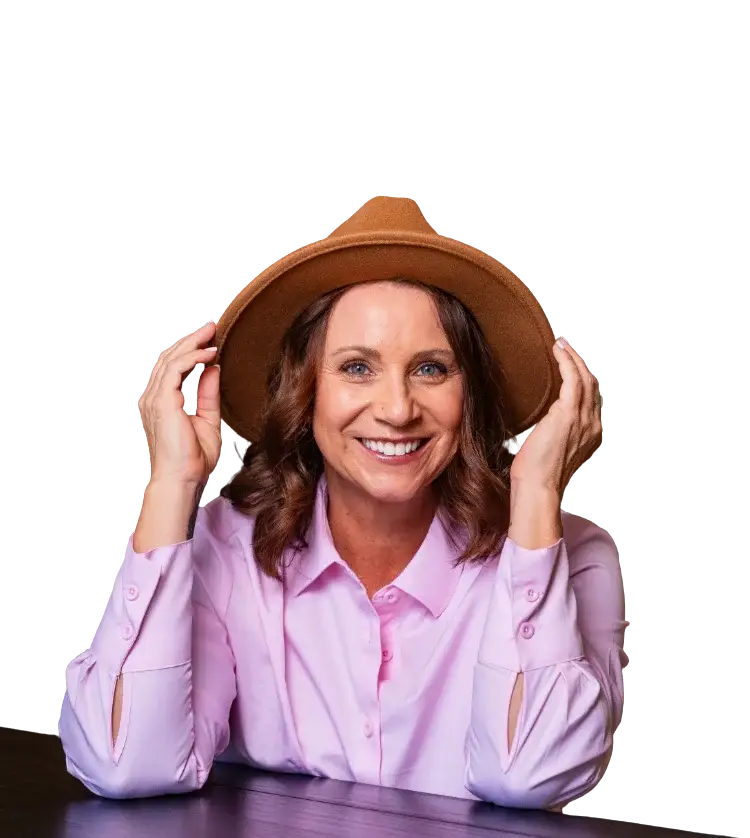 Smiling woman in a hat against a dark background.